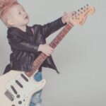 Theme - Boy Wearing Black Jacket Holding Electric Guitar