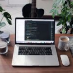 Plugins - macbook pro beside white ceramic mug on brown wooden table