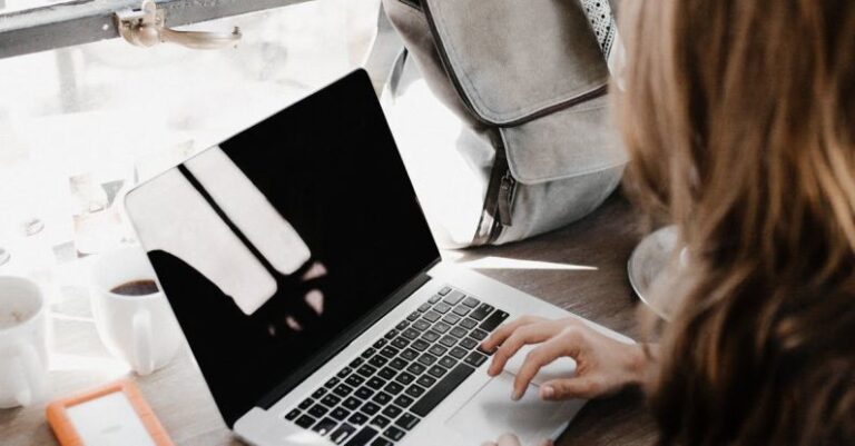 Backup - Close-up Photography of Woman Sitting Beside Table While Using Macbook