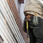 Builder - Man Wearing Black Denim Pants With Carrying Hammer on Holster