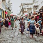 Customization - People walking down a cobblestone street in a market