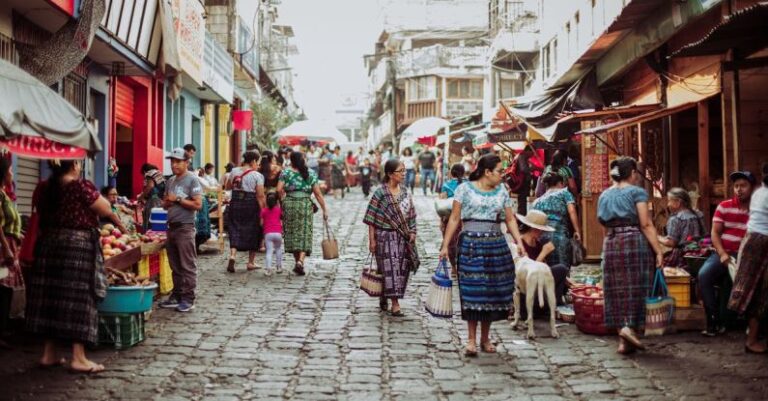 Customization - People walking down a cobblestone street in a market